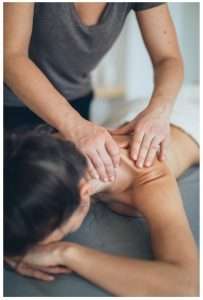 Physiotherapist Performing Therapeutic Massage on Client's back in Burwood clinic for pain relief, muscle tension reduction, and rehabilitation
